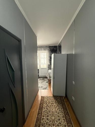 an empty hallway with a refrigerator in a room at fresh apartment in Bishkek