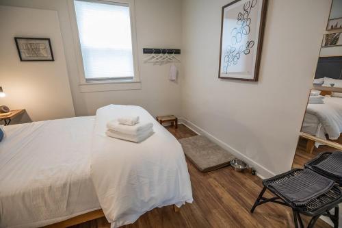 a bedroom with a white bed and a chair at Downtown Dwelling 1612 in Redding