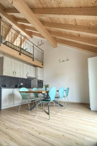a dining room with blue chairs and a table at La Clef des Franches in Saignelégier