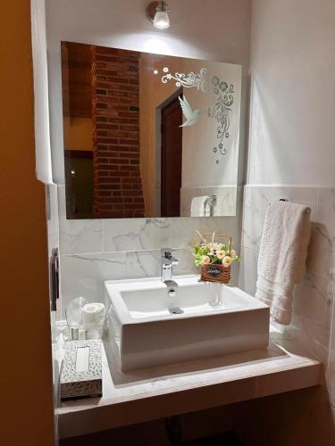 a bathroom with a sink and a mirror at Cabaña para pareja con Jacuzzi in Huasca de Ocampo