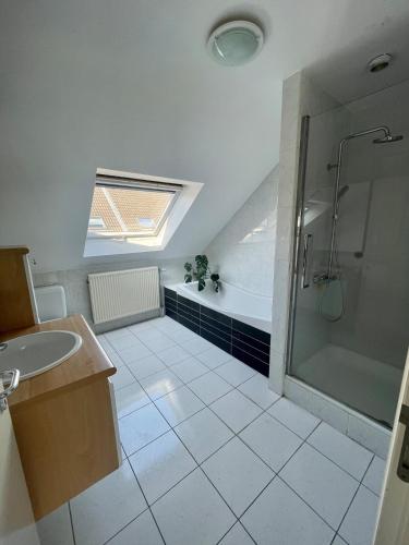 a bathroom with a shower and a sink and a tub at Lovely house next to Tomorrowland in Boom