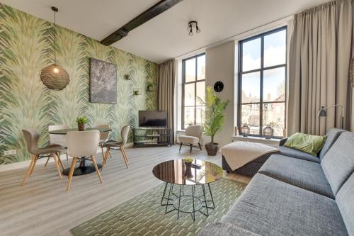 a living room with a couch and a table at The Dam Apartments in Middelburg