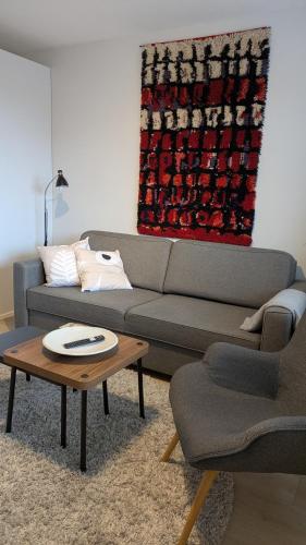 a living room with a couch and a coffee table at Midtown Jeppis in Pietarsaari