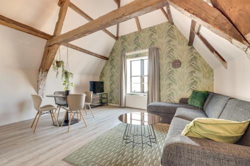 a living room with a couch and a table at The Dam Apartments in Middelburg