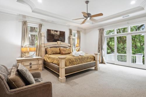 a bedroom with a bed and a ceiling fan at 340 Low Oak Woods Road by Akers Ellis Rentals in Kiawah Island