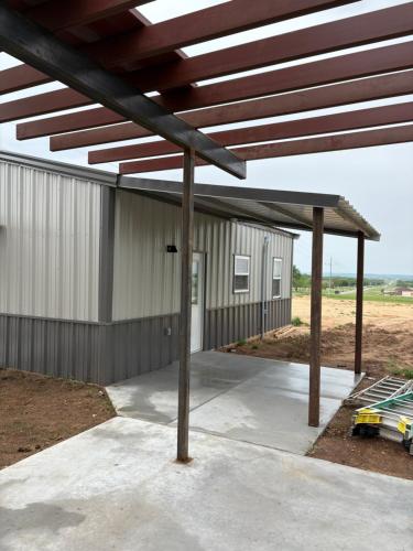 a metal building with awning and a garage at Nexlevel Rentals in Davis