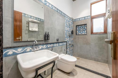 a bathroom with a sink and a toilet at Wandr Indiranagar, Bangalore in Bengaluru