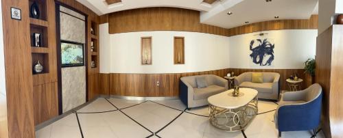 a lobby with wood paneling and a table and chairs at ديباج للشقق المخدومة in Dammam