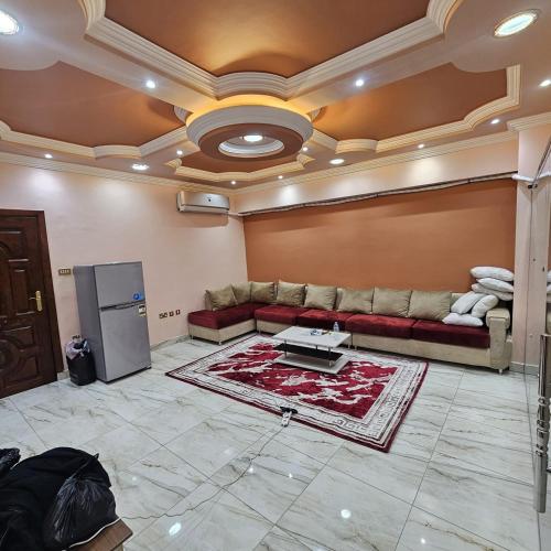 Una sala de estar con un sofá y un refrigerador. en الاقصر, en Luxor