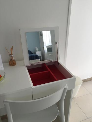 a white drawer with a mirror in a room at B&B Sorgente 23 in Salerno