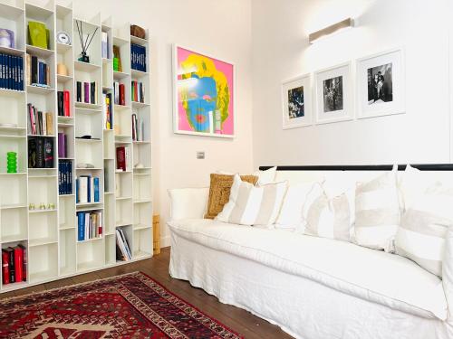 - un salon avec un canapé blanc et des étagères dans l'établissement ComeCasa Two-Bedroom House on the Harbor, à Saint-Tropez