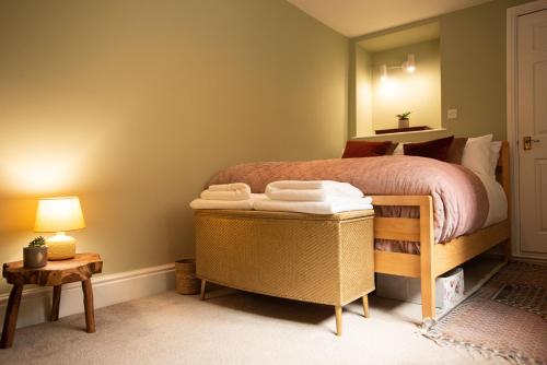 a bedroom with a bed with a stack of towels at Walker's Rest in Newland
