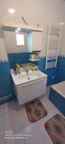 a bathroom with a sink and a mirror and a tub at Beautiful Apartment in Kantaoui Sousse tourist area in Hammam Sousse