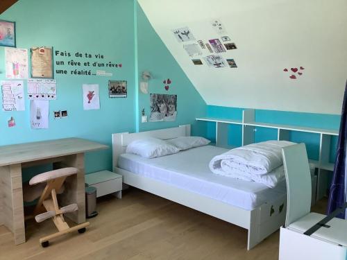 une petite chambre avec un lit et un bureau dans l'établissement Charmante maison située à 150 m de la plage, à Plérin