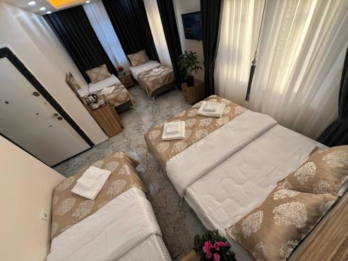 a hotel room with two beds and a couch at Hotel By Historia in Istanbul
