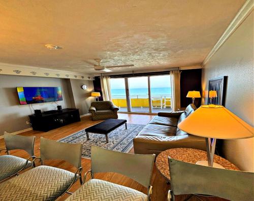 a living room with a couch and a table at Vacation in Comfort and luxury - 1 BR Direct Oceanfront Wyndham Ocean Walk 1505 in Daytona Beach