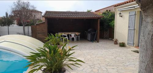 une arrière-cour avec une piscine, une table et une maison dans l'établissement Maison de vacances avec 4 chambres Clim et WiFi, à Claira