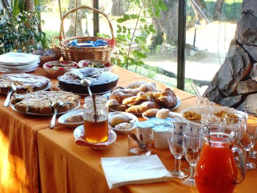 einen Tisch mit Speisen, Getränken und Brot darauf in der Unterkunft Park Hotel Cilento in Marina di Camerota