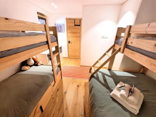 une petite pièce avec deux lits superposés dans l'établissement Résidence Flocon Bleu - Un cocon de standing au cœur des Gets MAE-4601, aux Gets