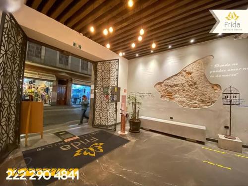 a lobby of a building with a large artifact on the wall at Hotel Frida in Puebla