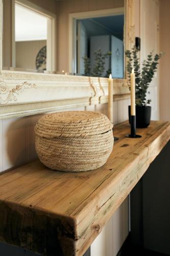 a wooden counter with two candles and a mirror at Home in Sylta