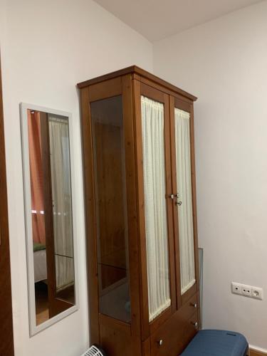 a wooden cabinet and a mirror in a room at Casa Abuela Cati in Sanlúcar de Guadiana