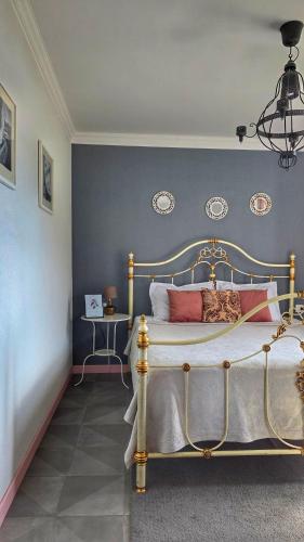 a bedroom with a bed with a blue wall at Apartment Mint&Rose in Risan