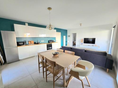 un salon avec une table et un canapé dans l'établissement PAVLOVA : Calme, vue, élégant, spacieux, sûr et central, à Montpellier