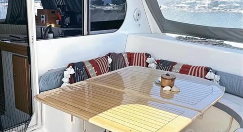 a table on a boat with a coffee cup on it at Principessa dei draghi Full Day and Night Experience in Izola