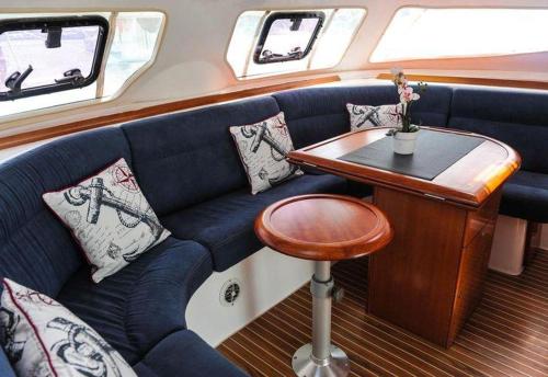 a blue couch on a boat with a table at Principessa dei draghi Full Day and Night Experience in Izola
