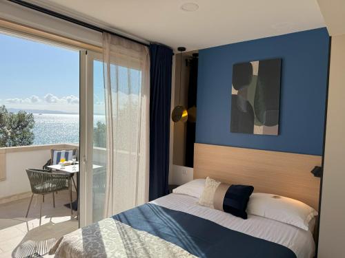 a bedroom with a bed and a view of the ocean at Beach Apartments Ankora in Makarska
