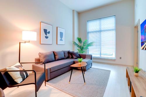 a living room with a couch and a table at Convenient Apartment Near Major Sights in Arlington
