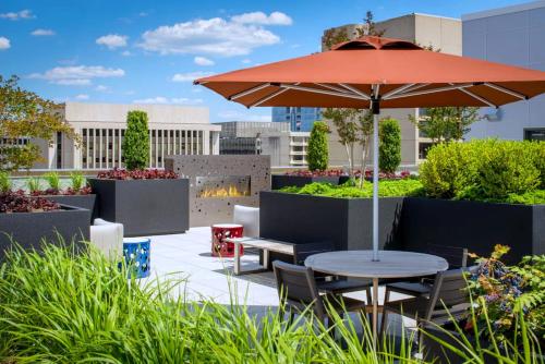 a patio with a table and an umbrella at Convenient Apartment Near Major Sights in Arlington