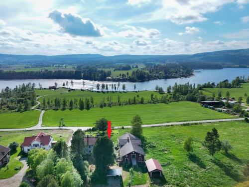 an aerial view of a house on a hill next to a lake at Norrgården Hälsingland in Vallsta