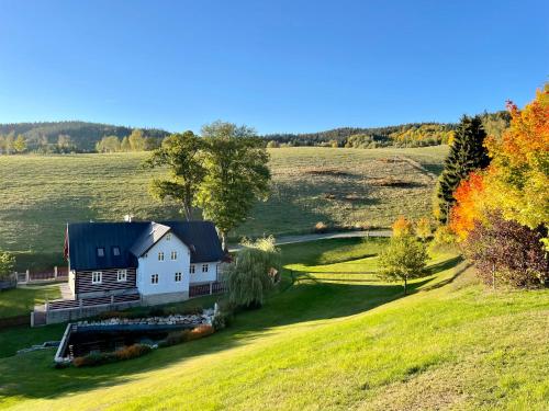 a house on a hill in the middle of a field at Chata Moni in Jablonec nad Nisou