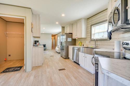 a kitchen with white cabinets and stainless steel appliances at 8 Mi to Main Street Home with Yard in Bedford! in Bedford