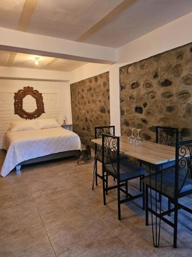 a bedroom with a bed and a table and chairs at Central Campestre Apartment in Popayan