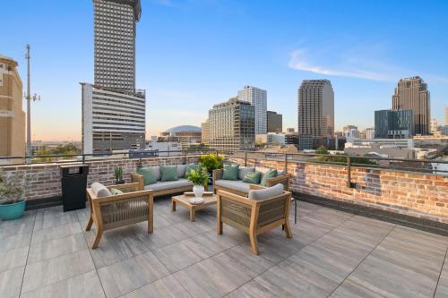 a rooftop patio with furniture and a view of the city at 888 Baronne in New Orleans