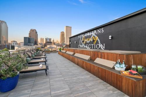 a rooftop bar with benches and a city skyline at 888 Baronne in New Orleans