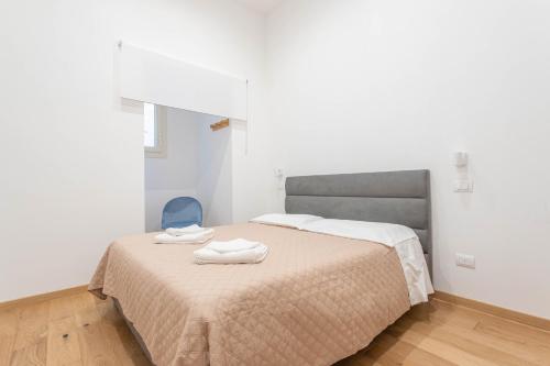 a bedroom with a bed and a blue chair at AM6 - Dimora del Borgo in Perugia
