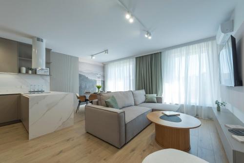 a living room with a couch and a table at Apartamenty SOWIE SZCZYTY in Dzierżoniów