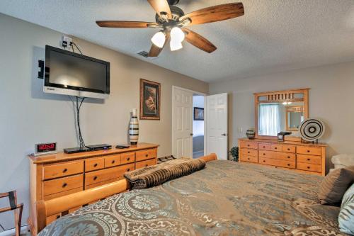a bedroom with a bed and a flat screen tv at 7 Mi to Riparian Preserve Family Home with Yard! in Mesa