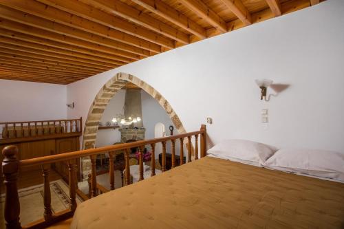 a bedroom with a bed and an arched doorway at Socrates traditional house in Haraki