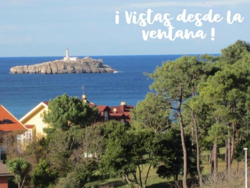 a view of a island in the ocean with a lighthouse at "LAS CAMELIAS SOMO" un lugar para desconectar!! Vistas al MAR!! in Somo