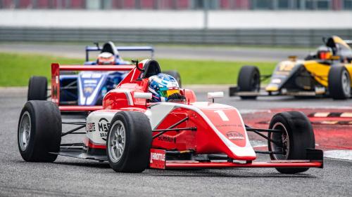 a race car on a race track with other cars at InterContinental Indianapolis by IHG in Indianapolis