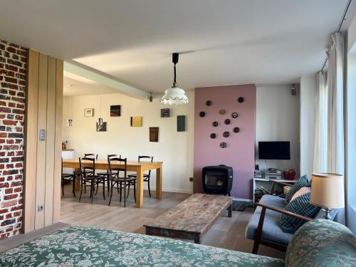 ein Wohnzimmer und ein Esszimmer mit einem Tisch und Stühlen in der Unterkunft Vakantiehuis in Flanders Fields in Zonnebeke