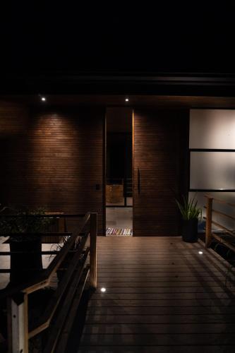 a dark room with a wooden deck with a bench at Casa VISTA PARAISO in Santa Teresa Beach