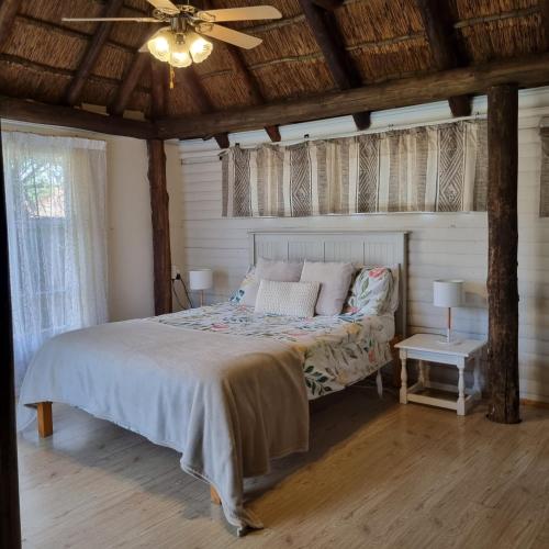 a bedroom with a bed and a ceiling fan at Kruin cottage in Pretoria
