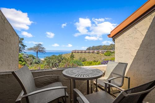 a patio with a table and chairs and the ocean at Spectacular Ocean View in Aptos