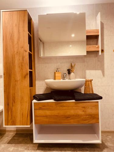 a bathroom with a sink and a counter with a mirror at Ferienwohnung Leadro in Kurort Oberwiesenthal